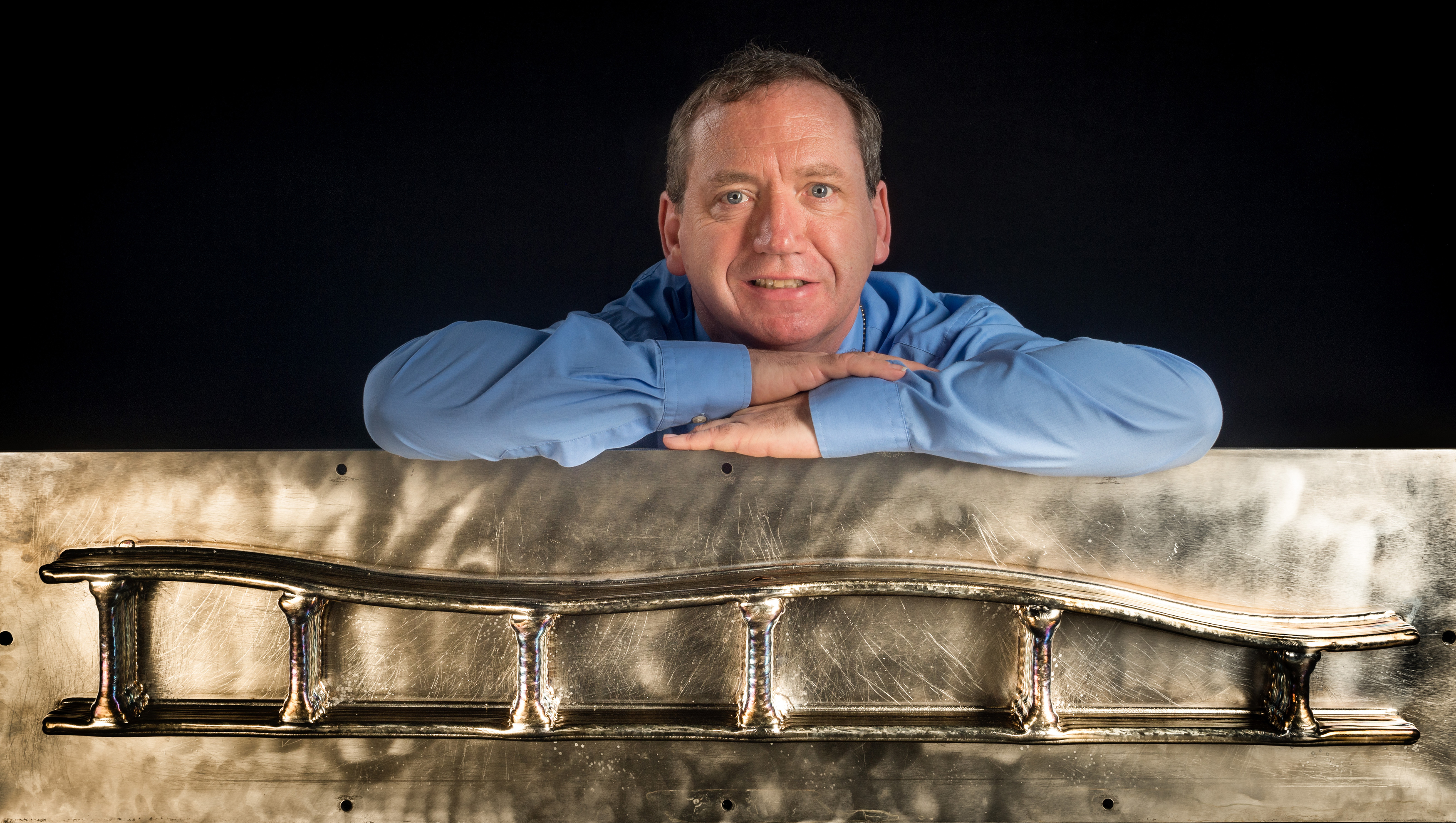 Mark Potter, a member of the ALM team at BAE Systems with long titanium spar section