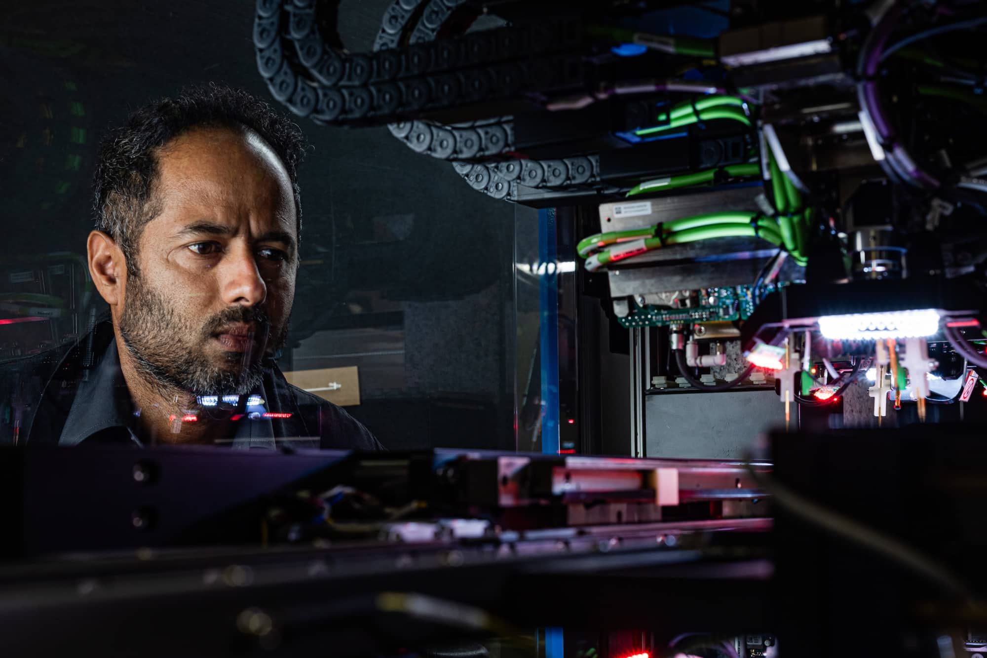 Employee inspecting wiring of machinery