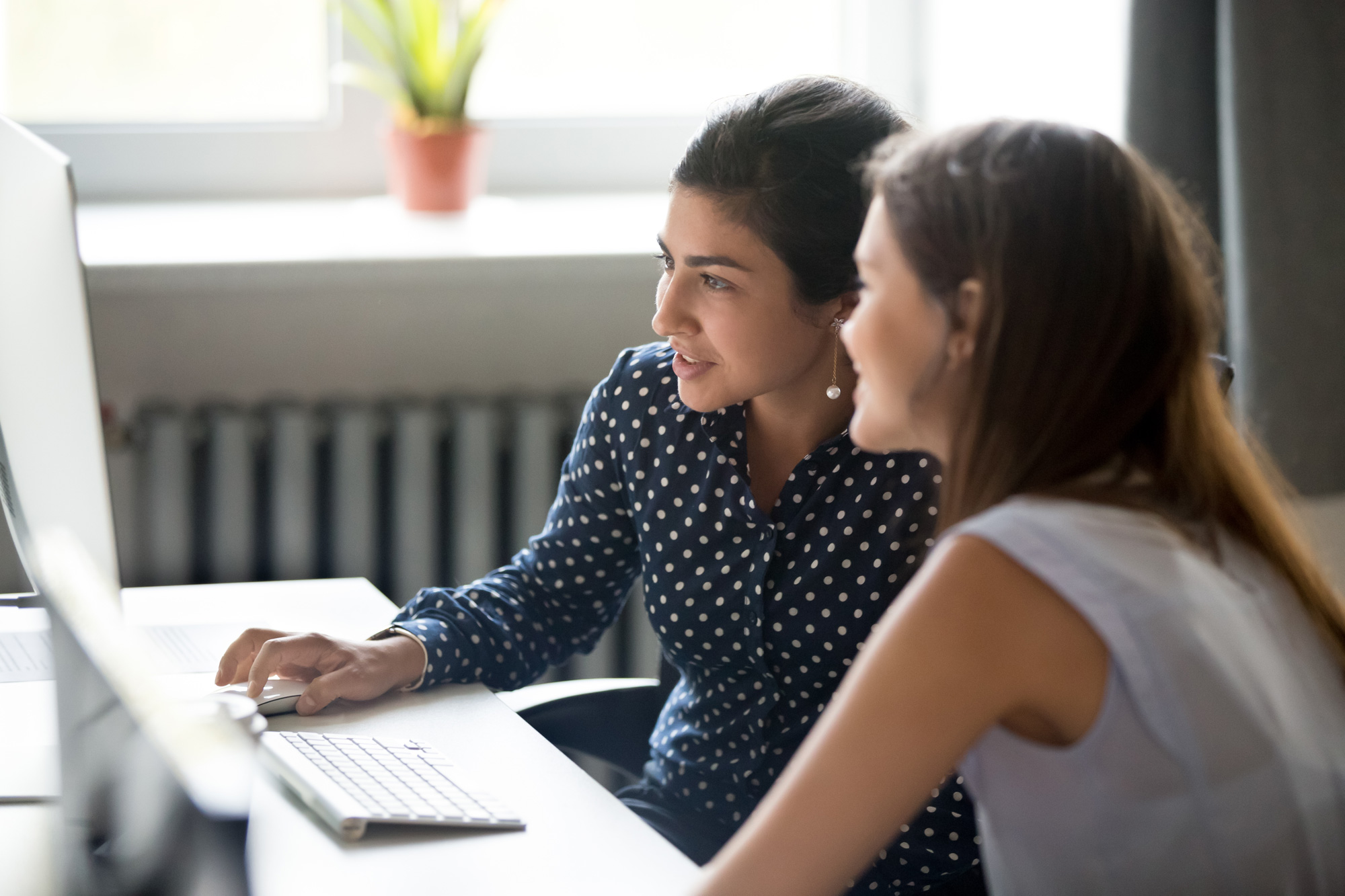 Two women working on laptop