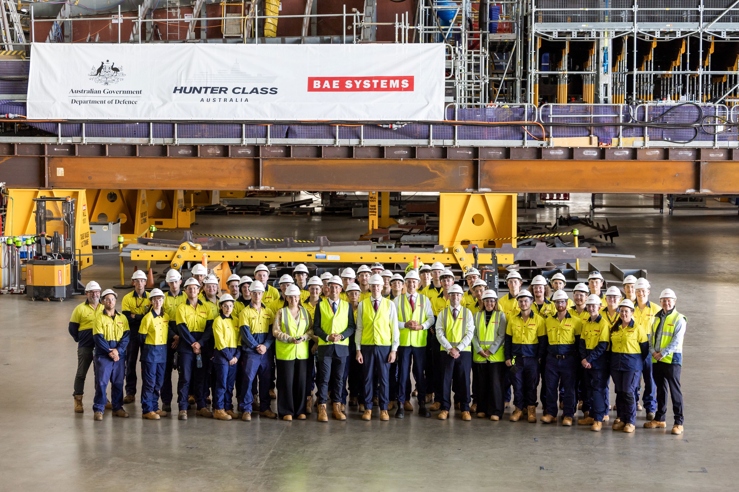 Surface Ships MD David Shepherd and SA Premier Peter Malinauskas posing in a group shot with our first year apprentices at Osborne