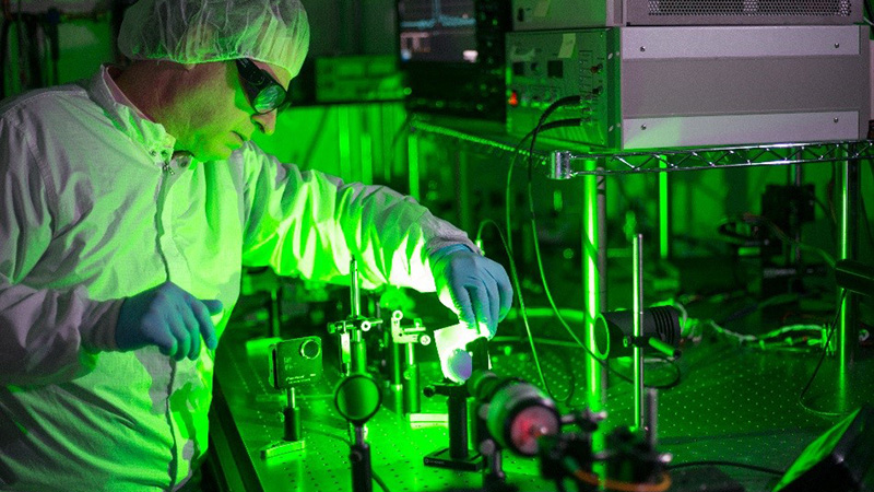 A researcher in our EO/IR Sensor laboratory a testing new laser technology on a custom optical table.