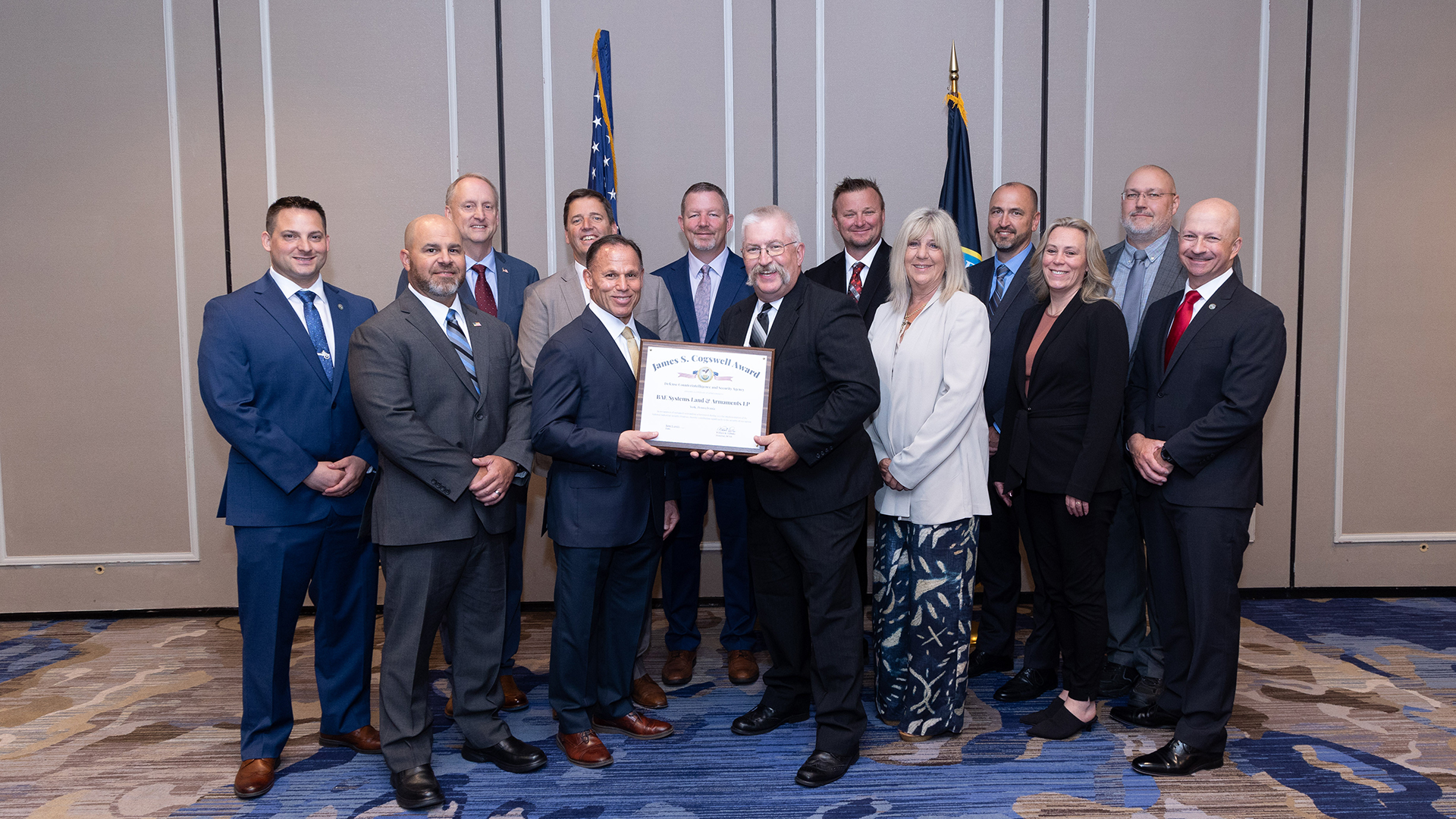 A group photo of York facility employees standing together with their Cogswell Award in hand.