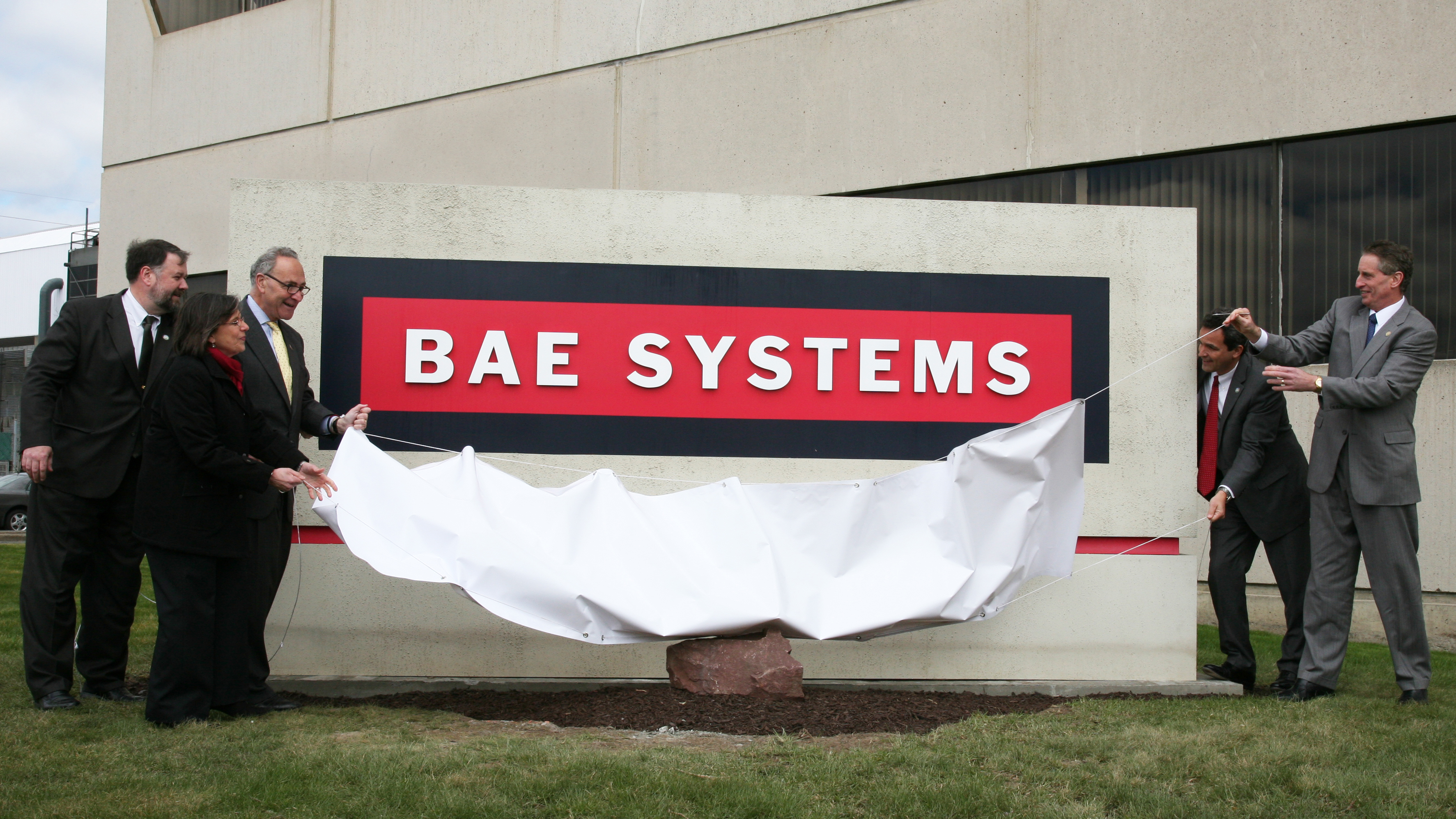 BAE Systems sign is unveiled at the new Endicott facility.