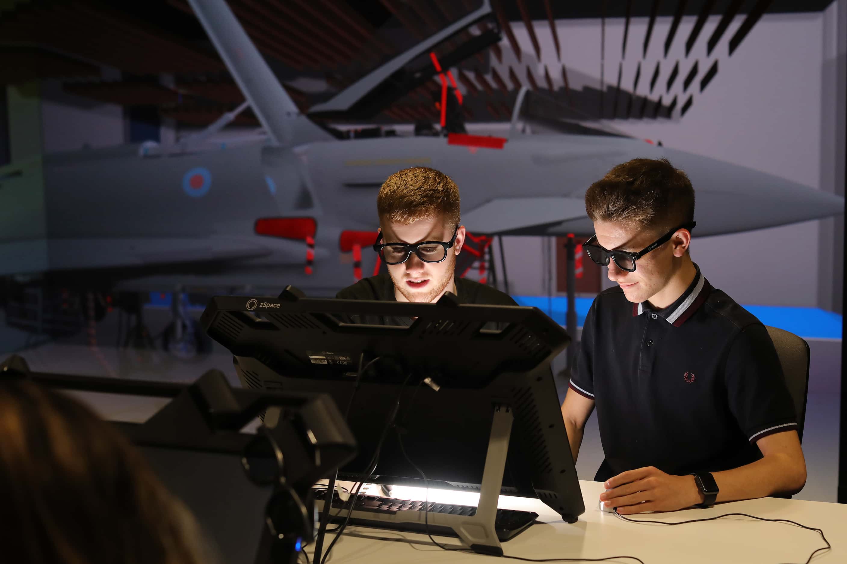 Two employees examining a screen