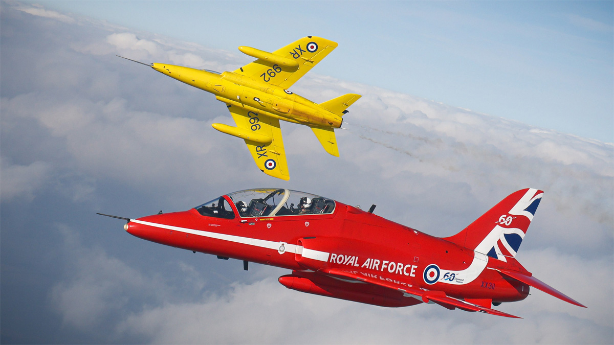 Red Arrows and a yellow Gnat in flight. 