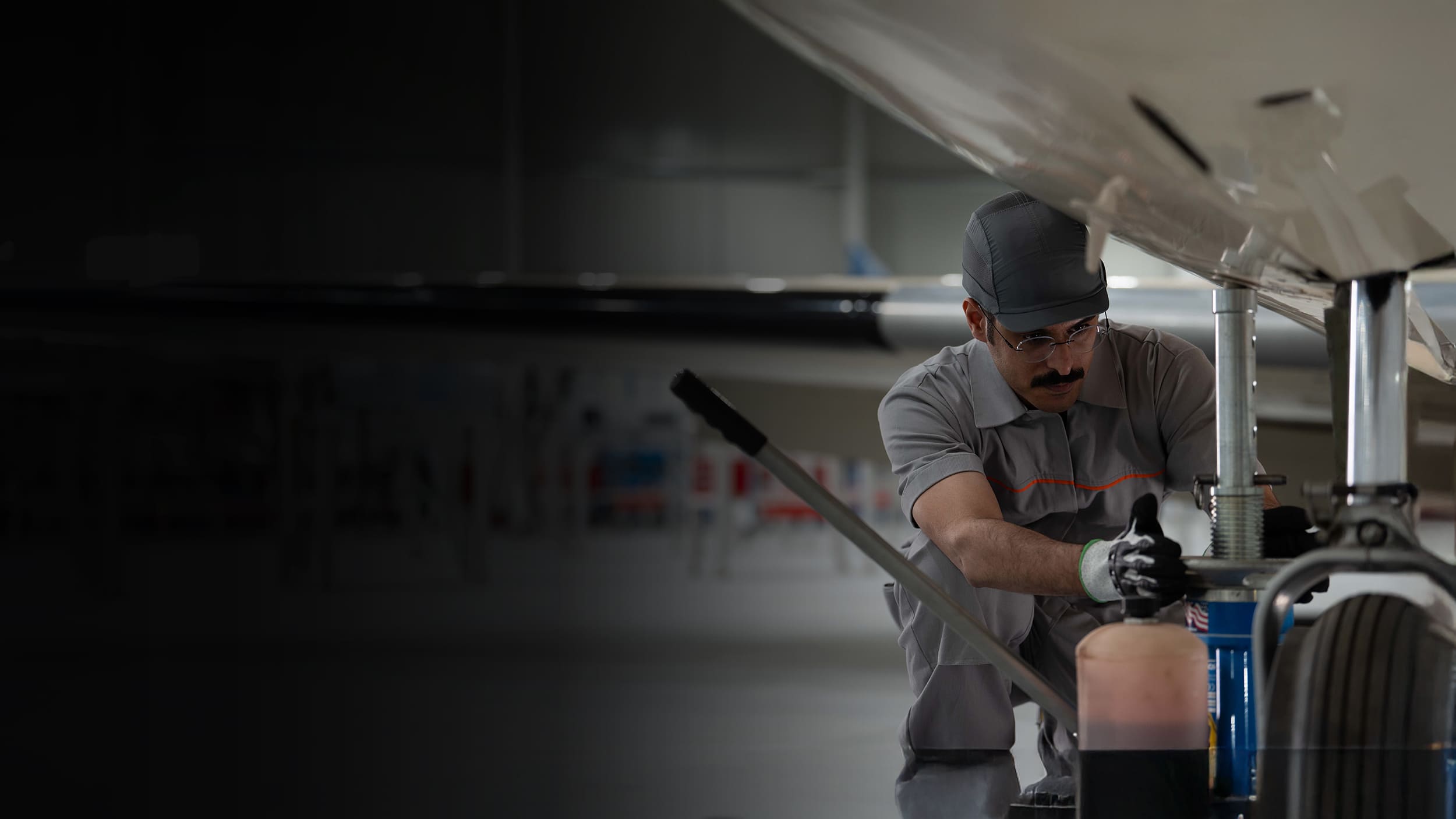 Air crew crouching by plane wheel
