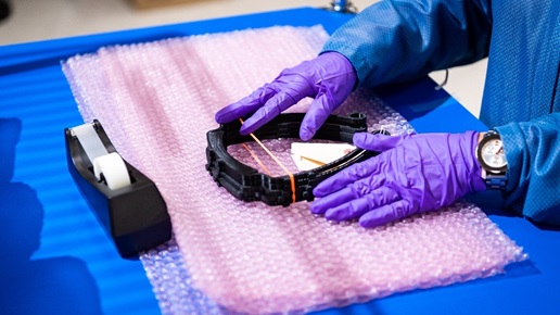 APKWS employee packages 3D printed face shield frames in Hudson, New Hampshire.