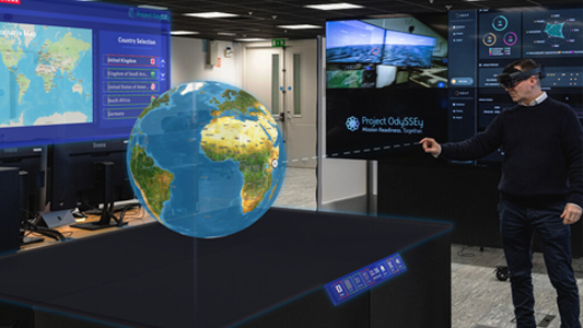 Employee interacts with holographic globe inside the single synthetic military training environment