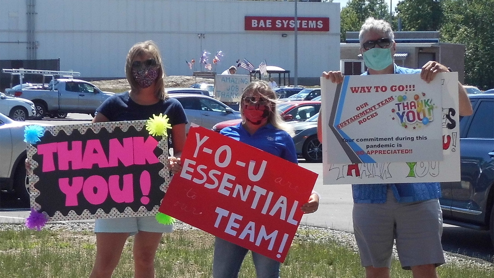 Members of BAE Systems' F-35 team hold handmade thank-you signs in a show of support and gratitude for front-line workers.