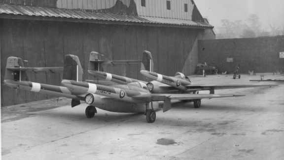 DH100 Vampire F.Mk1's (TG278 & TG285) outside hangar in 'naval stack'. DH100 Vampire F.Mk1's (TG278 & TG285) outside hangar in 'naval stack'.