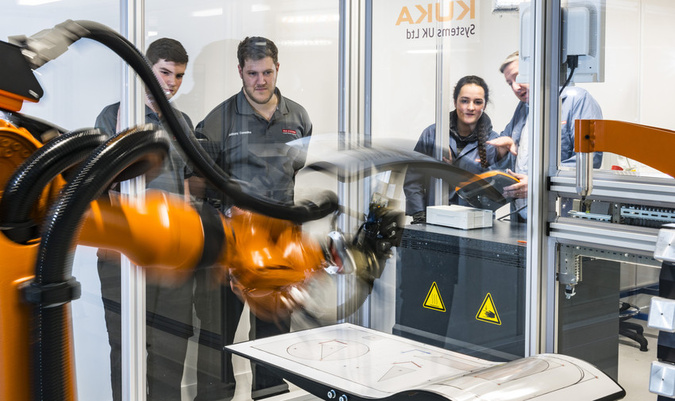 Image of apprentices being trained on the Kuka robot Image of apprentices being trained on the Kuka robot