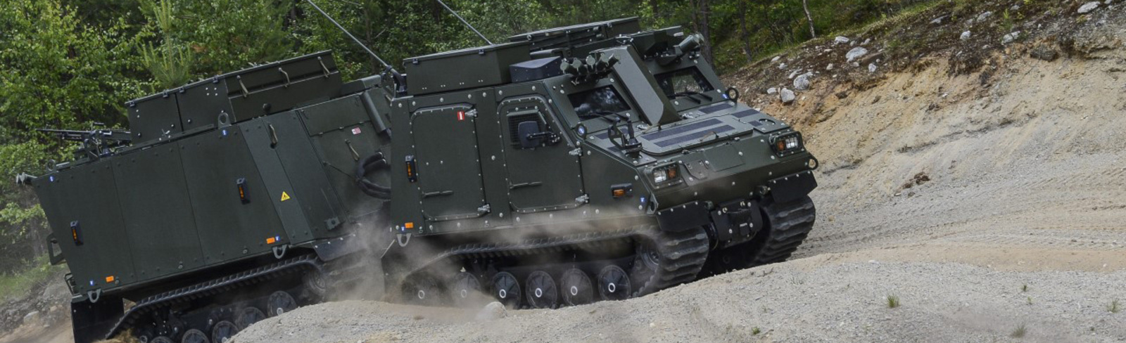 BvS10 drives through sand in forest