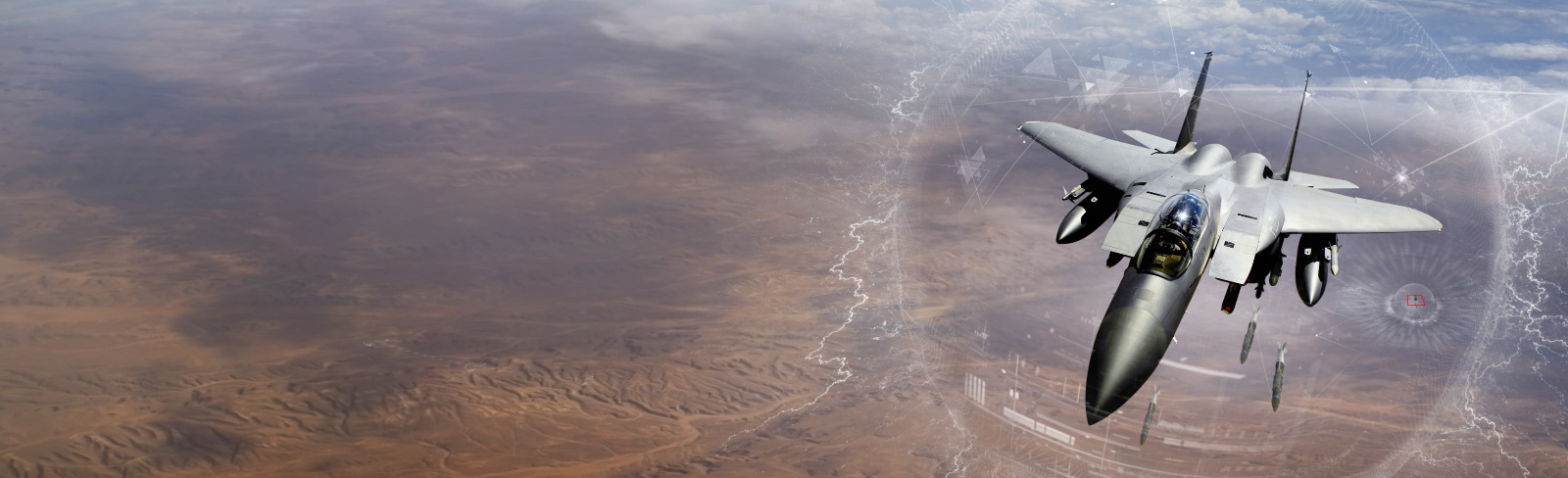 An F-15 flies over a desert scenario. An artist’s overlay depicts GPS capabilities.