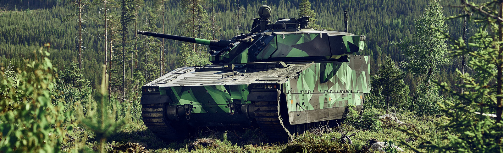 A green-camouflaged CV90 MkIV positioned hillside in a remote wooded area. Supreme mobility, exceptional protection, and outstanding lethality.