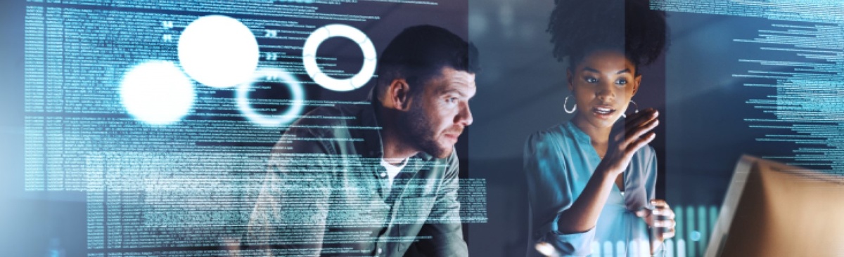 Two people looking at a computer screen with digital graphics overlaid
