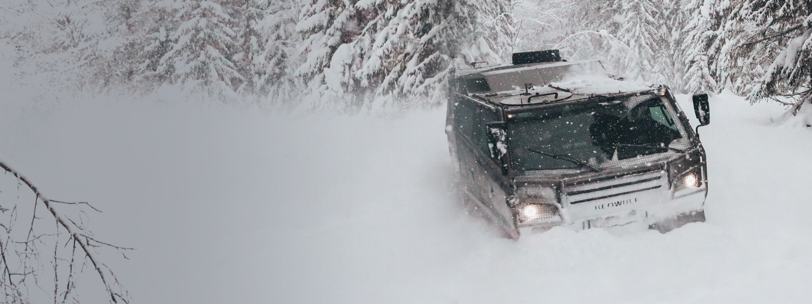 BAE Systems' Beowulf vehicle moving through deep snow.