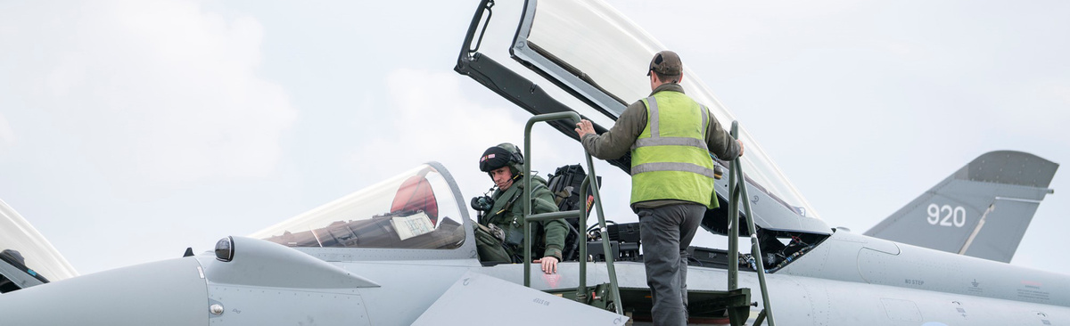 A ground crew technician speaks with an RAF Typhoon pilot