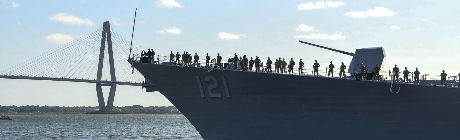Side naval ship sailing through the ocean with a Mk 45 Naval Gun on the deck (U.S. Navy Photo)