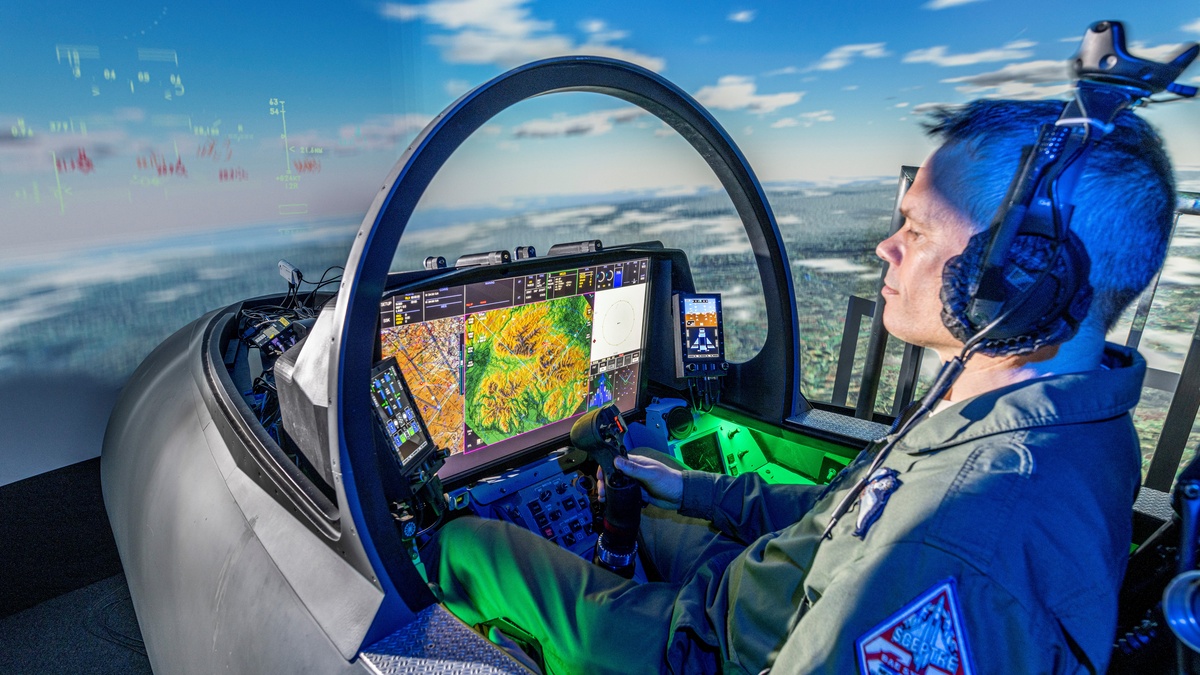 A pilot sitting in a cockpit with a Large Area Display A pilot sitting in a cockpit with a Large Area Display
