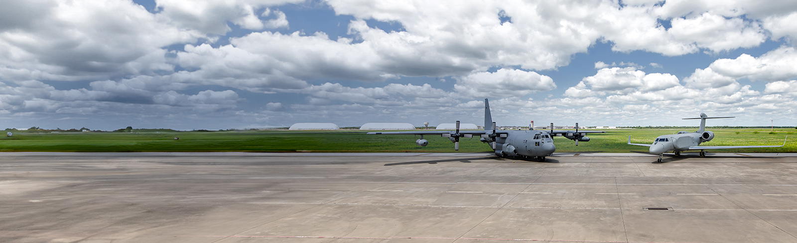 A EC-130H stands on the tarmac beside an EC-37B electromagnetic attack mission aircraft.